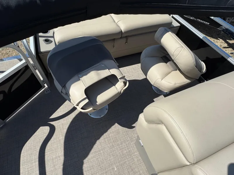 Slide: The Image of 2023 Sun Tracker SportFish 22 XP3 interior with beige seating and carpeted flooring. - 13