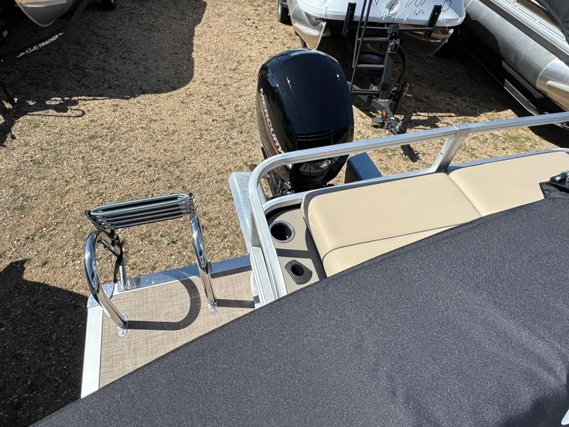 Slide: The Image of 2023 Sun Tracker SportFish 22 XP3 boat with motor and swim ladder, outdoor display. - 14