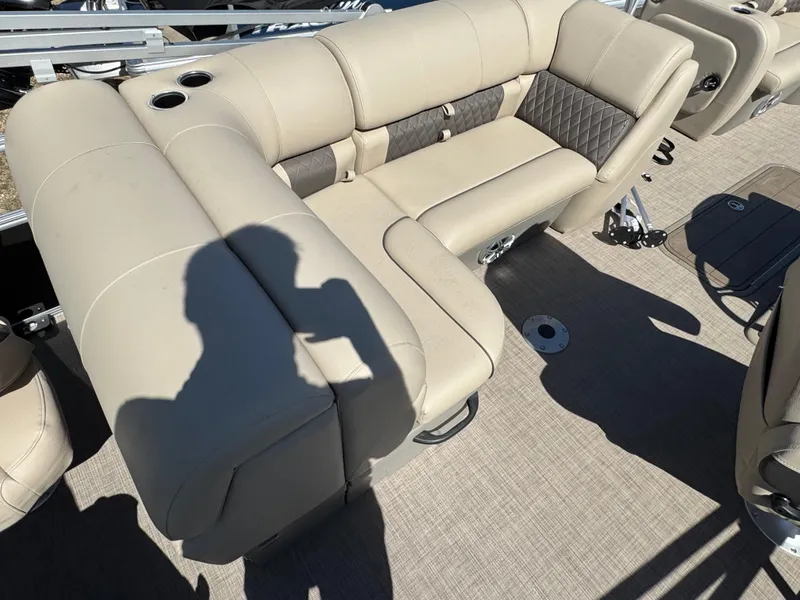 Slide: The Image of 2023 Sun Tracker SportFish 22 XP3 boat interior with beige seating and cup holders. - 15