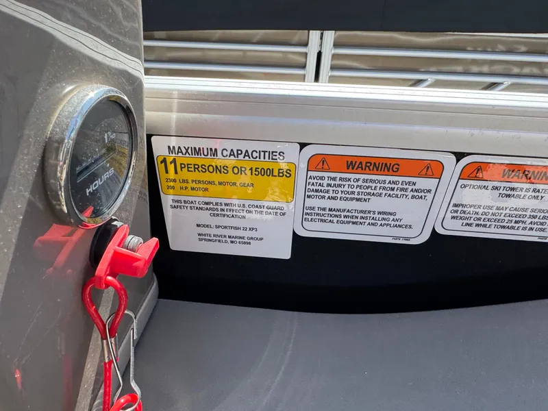 Slide: The Image of 2023 Sun Tracker SportFish 22 XP3 capacity label, showing maximum 11 persons or 1500 lbs. - 17
