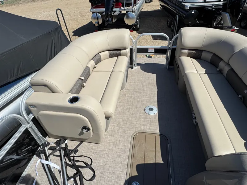Slide: The Image of 2023 Sun Tracker SportFish 22 XP3 pontoon boat interior with beige seating and cup holders. - 19