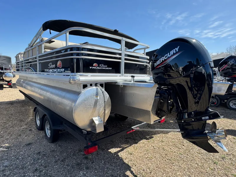 Slide: The Image of 2023 Sun Tracker SportFish 22 XP3 pontoon boat with Mercury engine, parked on a trailer. - 5