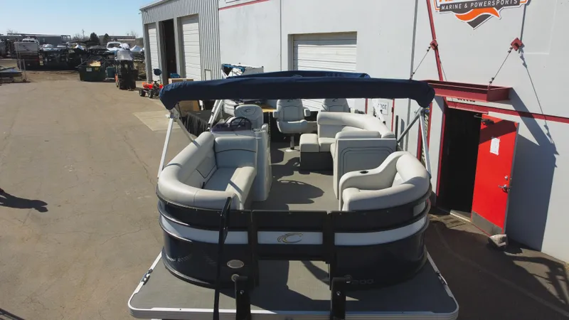 Slide: The Image of 2022 Crest Classic Fish 200 SF pontoon boat parked outside a warehouse. - 4