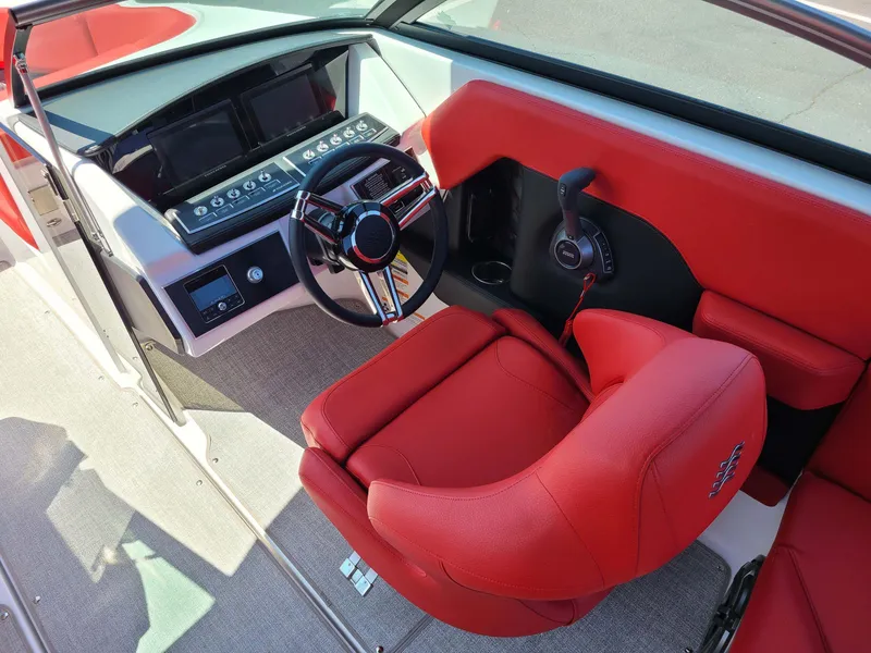 Slide: The Image of 2023 Four Winns H2 Surf boat interior with red seating and modern dashboard. - 6