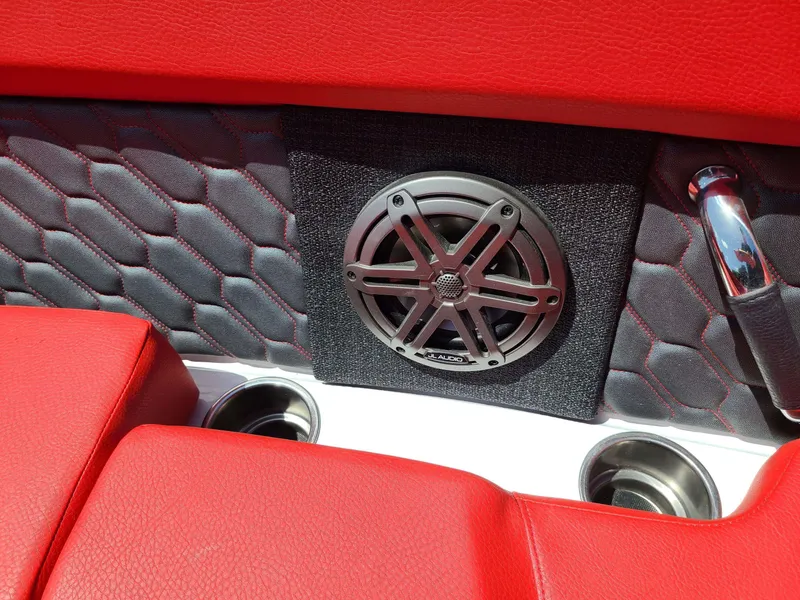 Slide: The Image of Red interior of 2023 Four Winns H2 Surf boat with speaker and cup holders. - 9