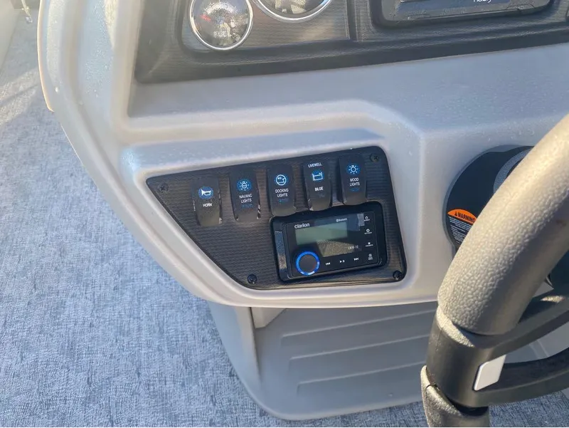 Slide: The Image of Control panel of 2025 Trifecta LE Series 22RF LE boat with switches and stereo system. - 12