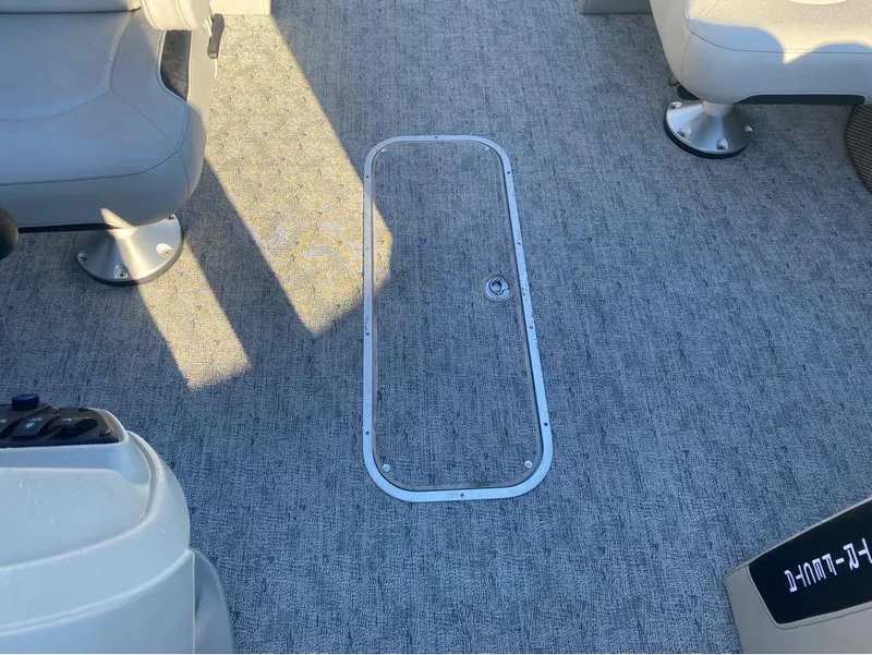 Slide: The Image of Interior of 2025 Trifecta LE Series 22RF LE boat, featuring gray carpet and seating. - 13