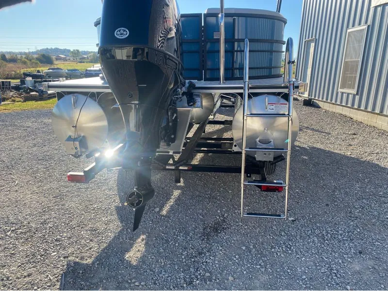 Slide: The Image of 2025 Trifecta LE Series 22RF LE pontoon boat rear view with motor and ladder. - 14