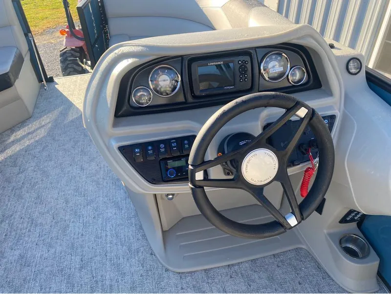 Slide: The Image of 2025 Trifecta LE Series 22RF LE boat dashboard with steering wheel and control panel. - 15