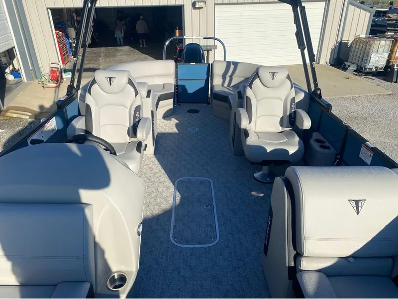 Slide: The Image of 2025 Trifecta LE Series 22RF LE pontoon boat interior with plush seating and modern design. - 2