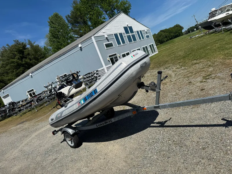 Slide: The Image of 2011 AB Inflatables Alumina 10 ALX boat on trailer, parked near a building. - 3