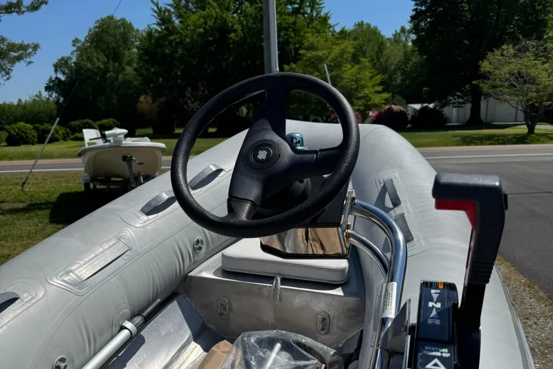 Slide: The Image of 2011 AB Inflatables Alumina 10 ALX boat, steering wheel and controls, parked outdoors. - 5