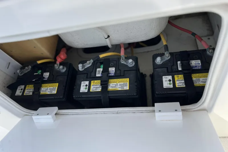 Slide: The Image of Three marine batteries in a 2018 Buddy Davis 28 Center Console boat compartment. - 12