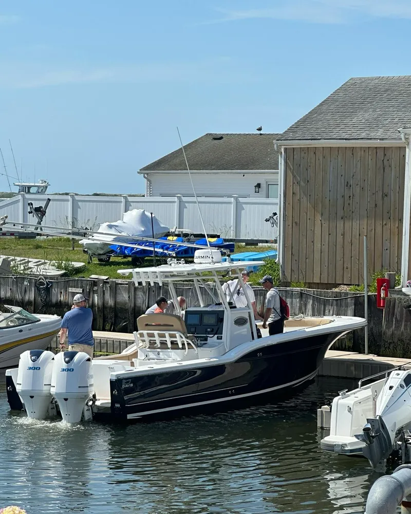 Slide: The Image of 2018 Buddy Davis 28 Center Console boat docked at marina. - 2