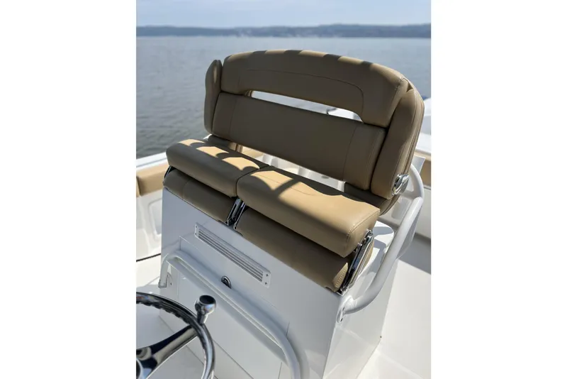 Slide: The Image of 2018 Buddy Davis 28 Center Console boat seat with tan upholstery, overlooking calm waters. - 6