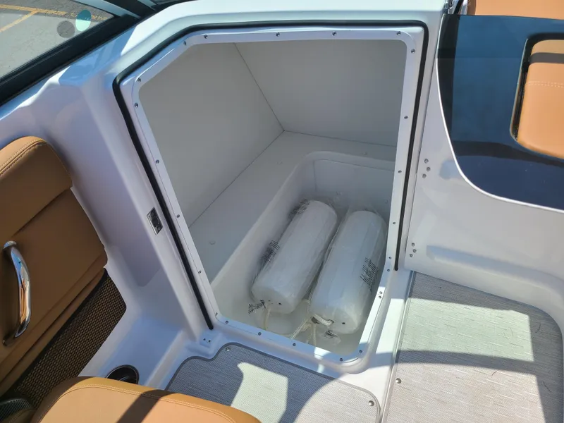 Slide: The Image of 2023 Four Winns HD3 boat storage compartment with white fenders inside. - 10