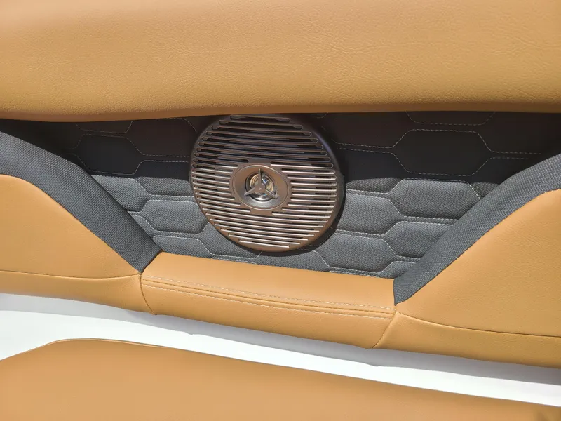 Slide: The Image of 2023 Four Winns HD3 boat interior with tan upholstery and speaker detail. - 14