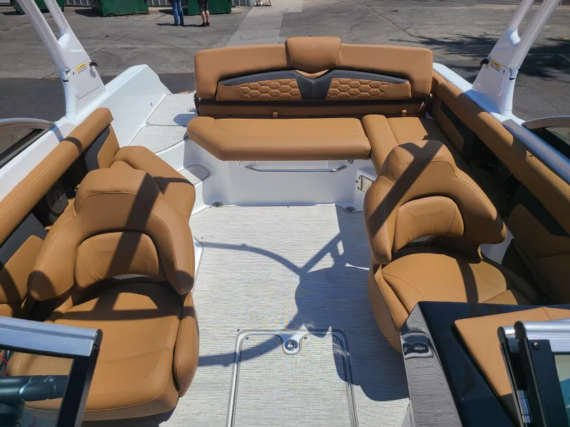 Slide: The Image of 2023 Four Winns HD3 boat interior with tan leather seating and modern design. - 15