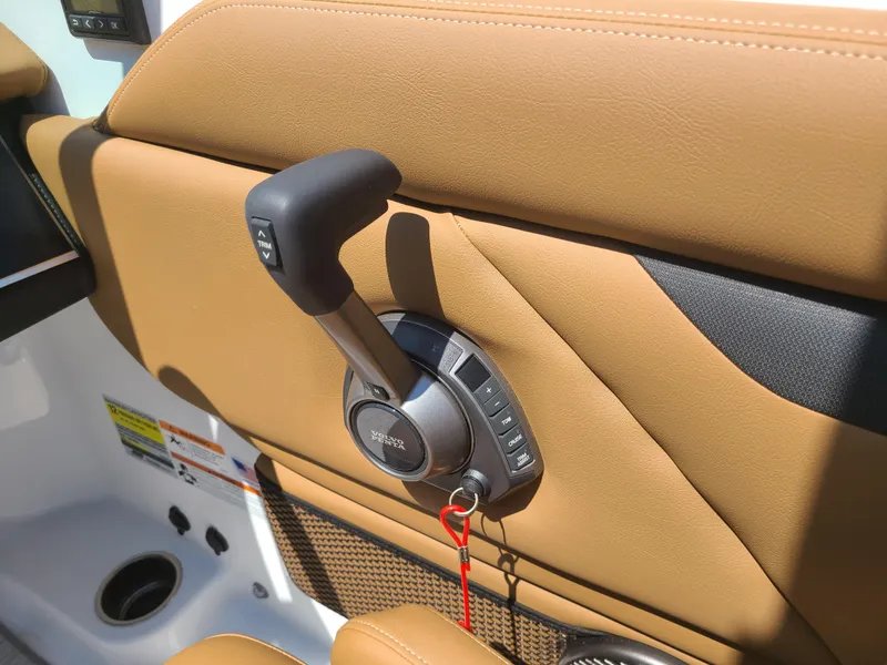 Slide: The Image of 2023 Four Winns HD3 throttle control on tan interior panel. - 18