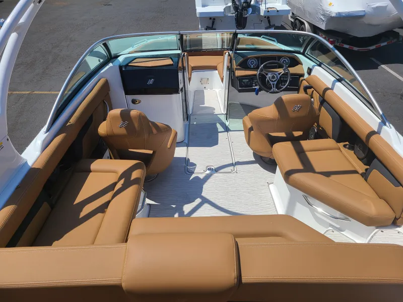 Slide: The Image of 2023 Four Winns HD3 boat interior with tan seating and modern dashboard. - 8