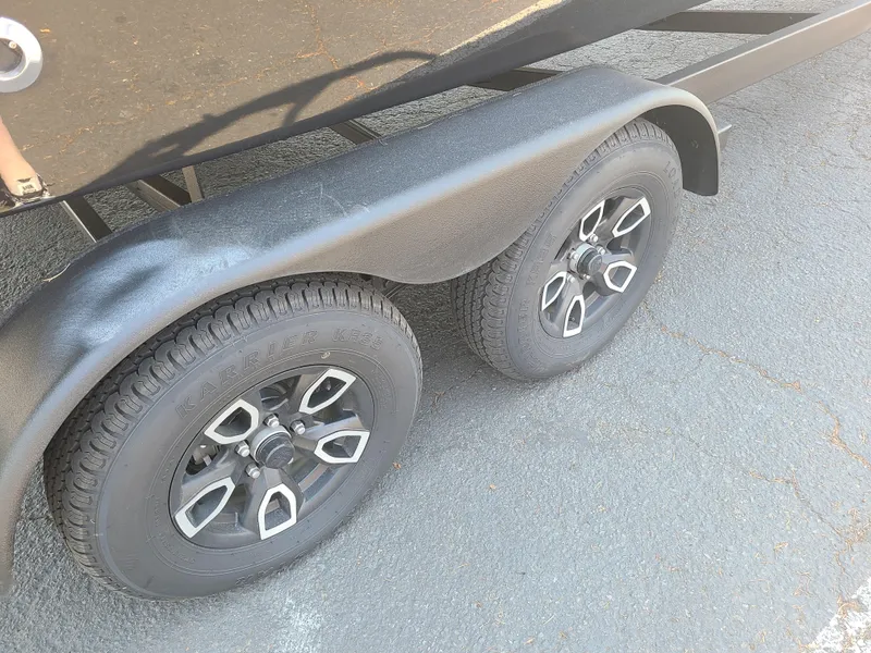 Slide: The Image of 2023 Four Winns HD3 trailer wheels on asphalt surface. - 3