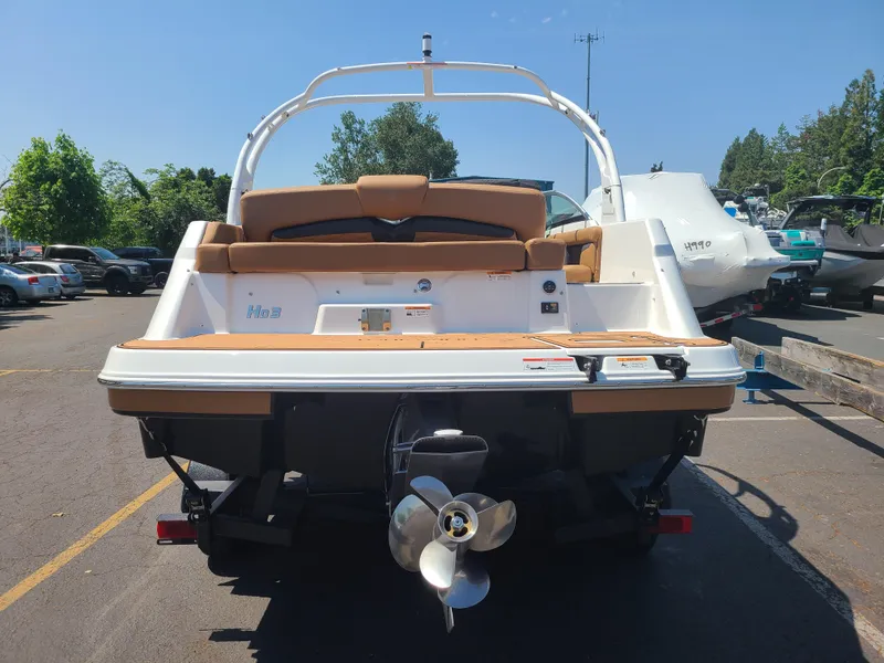 Slide: The Image of 2023 Four Winns HD3 boat, rear view, parked outdoors on a sunny day. - 5