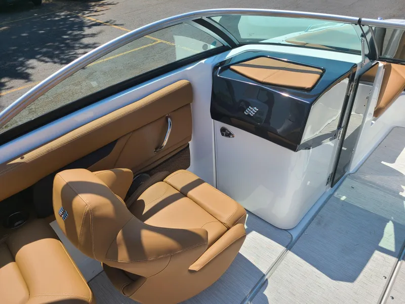 Slide: The Image of 2023 Four Winns HD3 boat interior with tan leather seating and sleek design. - 9