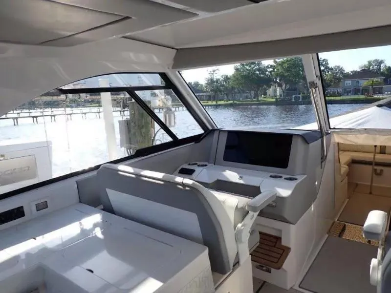 Slide: The Image of 2023 Regal LX36 yacht interior with modern helm and waterfront view. - 21