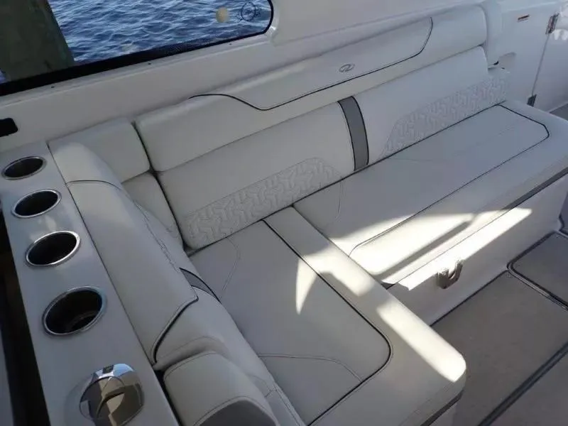 Slide: The Image of Luxurious seating area on 2023 Regal LX36 boat with cup holders and elegant upholstery. - 24