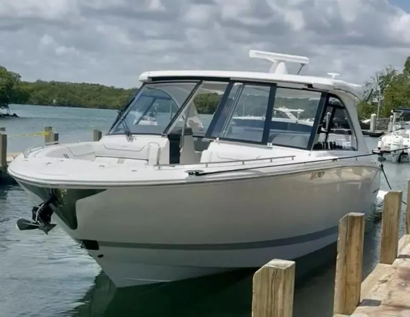 Slide: The Image of 2023 Regal LX36 boat docked by the water on a sunny day. - 3