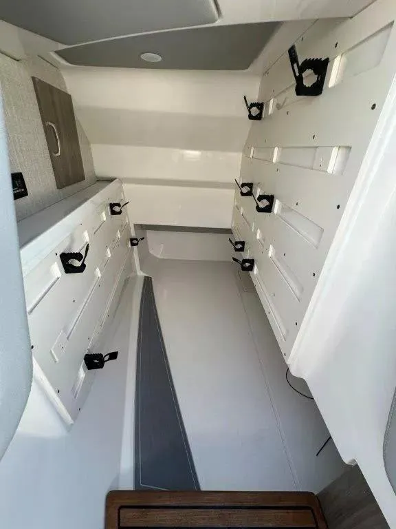 Slide: The Image of 2023 Regal LX36 boat interior with storage compartments and sleek design. - 5