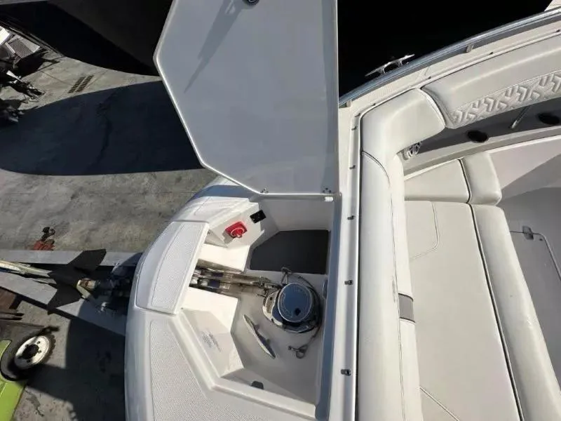 Slide: The Image of 2023 Regal LX36 boat interior with open storage compartment and seating area. - 8