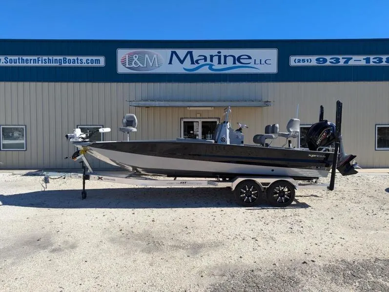 Slide: The Image of 2025 Xpress X23B Lounge boat parked outside L&M Marine LLC building. - 0