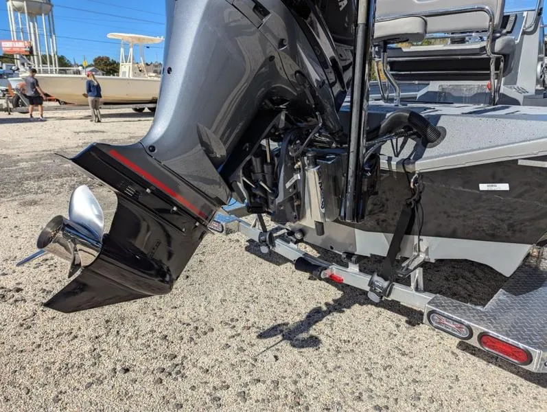 Slide: The Image of 2025 Xpress X23B Lounge boat with powerful outboard motor on trailer. - 10