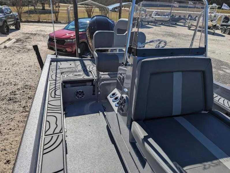 Slide: The Image of 2025 Xpress X23B Lounge boat with modern seating and sleek design in a sunny outdoor setting. - 13