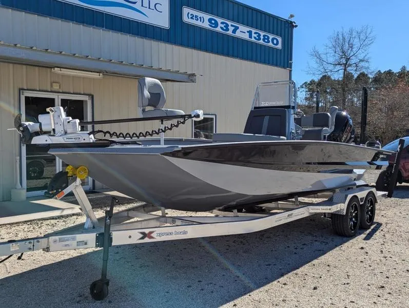 Slide: The Image of 2025 Xpress X23B Lounge boat on trailer outside dealership. - 4
