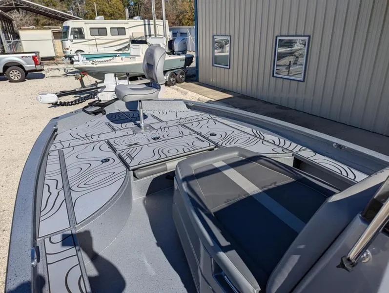 Slide: The Image of 2025 Xpress X23B Lounge boat with sleek design, docked near a building. - 6