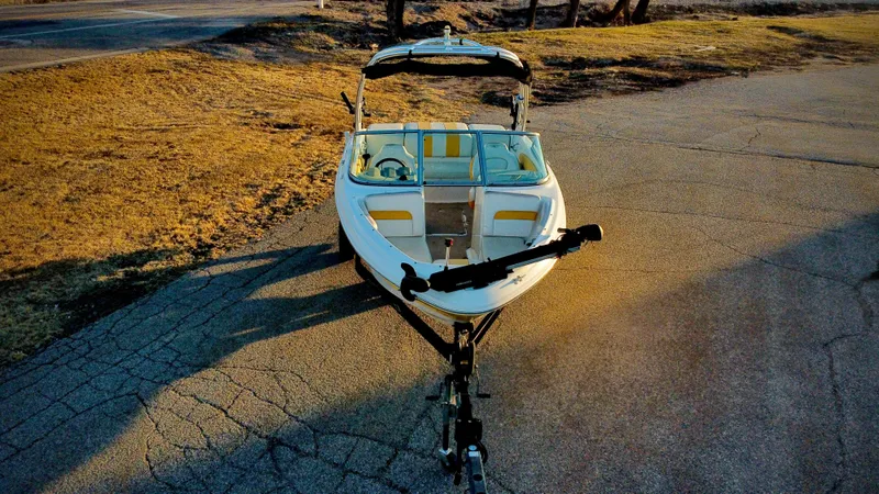 Slide: The Image of 2012 Chaparral 19 Ski & Fish H2O boat on trailer, parked on paved surface. - 1