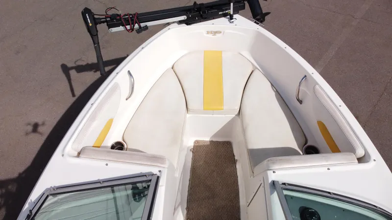 Slide: The Image of 2012 Chaparral 19 Ski & Fish H2O boat interior with yellow accents and seating. - 10