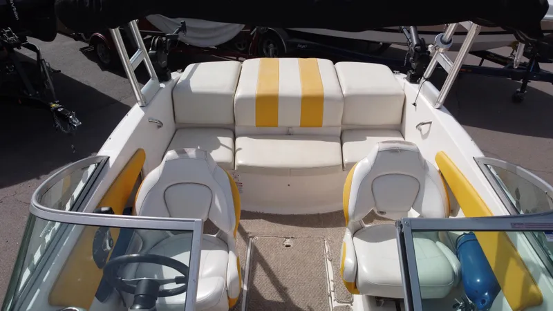 Slide: The Image of 2012 Chaparral 19 Ski & Fish H2O boat interior with yellow and white seating. - 12