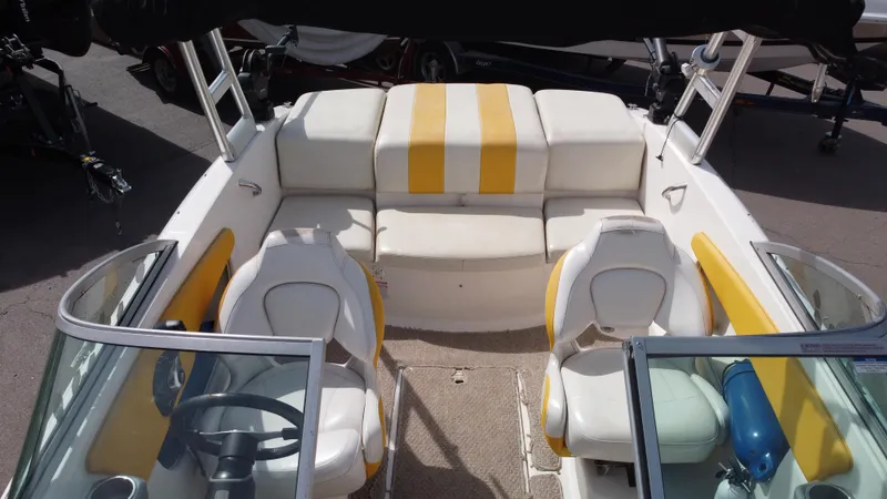 Slide: The Image of 2012 Chaparral 19 Ski & Fish H2O boat interior with yellow and white seating. - 17