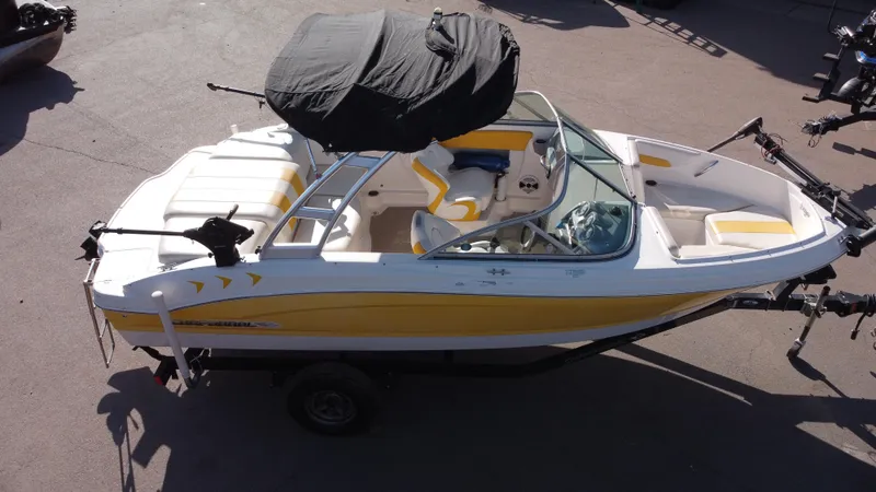 Slide: The Image of 2012 Chaparral 19 Ski & Fish H2O boat with yellow accents and covered canopy. - 19