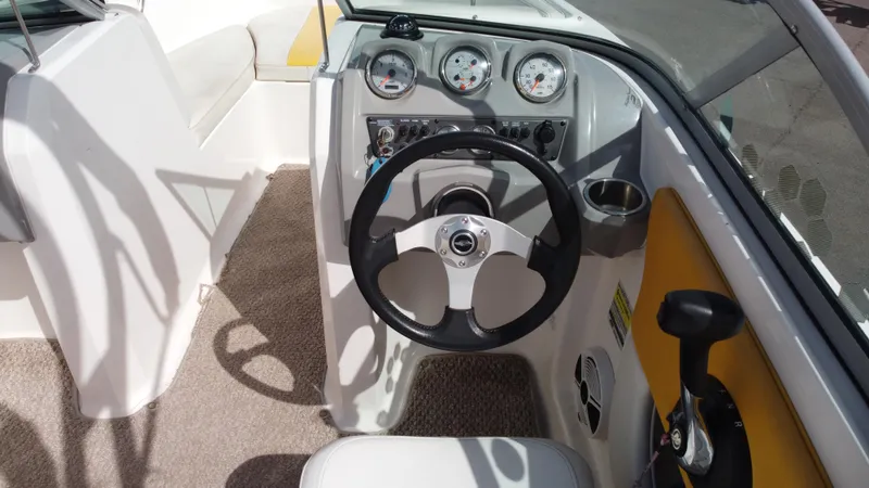 Slide: The Image of 2012 Chaparral 19 Ski & Fish H2O boat cockpit with steering wheel and gauges. - 9