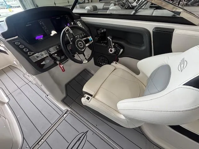 Slide: The Image of 2023 Chaparral 267 SSX boat cockpit with modern steering and luxurious seating. - 11