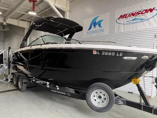 Slide: The Image of 2023 Chaparral 267 SSX boat on trailer in showroom, Munson Ski & Marine signage. - 14