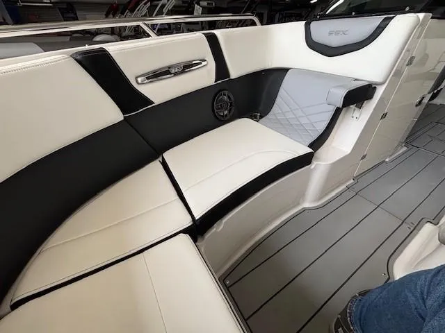 Slide: The Image of 2023 Chaparral 267 SSX boat interior with sleek black and white seating. - 18