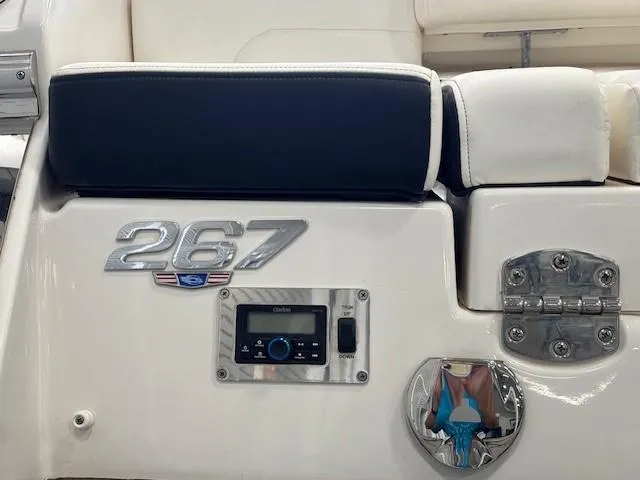 Slide: The Image of 2023 Chaparral 267 SSX boat interior with control panel and logo detail. - 19