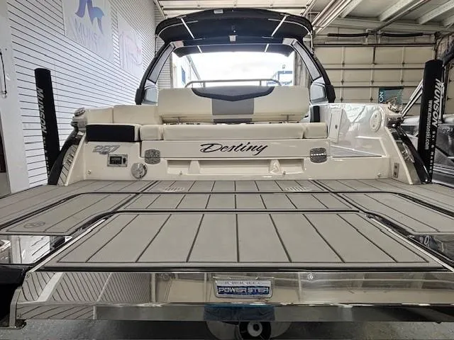 Slide: The Image of 2023 Chaparral 267 SSX boat with "Destiny" name, rear view in a showroom. - 20