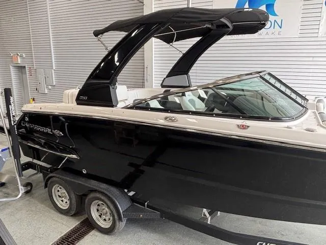 Slide: The Image of 2023 Chaparral 267 SSX boat with black hull on a trailer in a showroom. - 21
