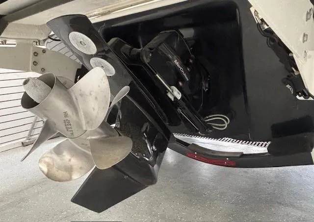Slide: The Image of 2023 Chaparral 267 SSX boat propeller and stern drive detail in a garage setting. - 26